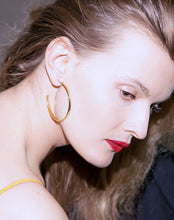 Indlæs billede til gallerivisning The cosmic golden band reminds us of the inevitable rhythm in the universe. Gold plated big hoops.